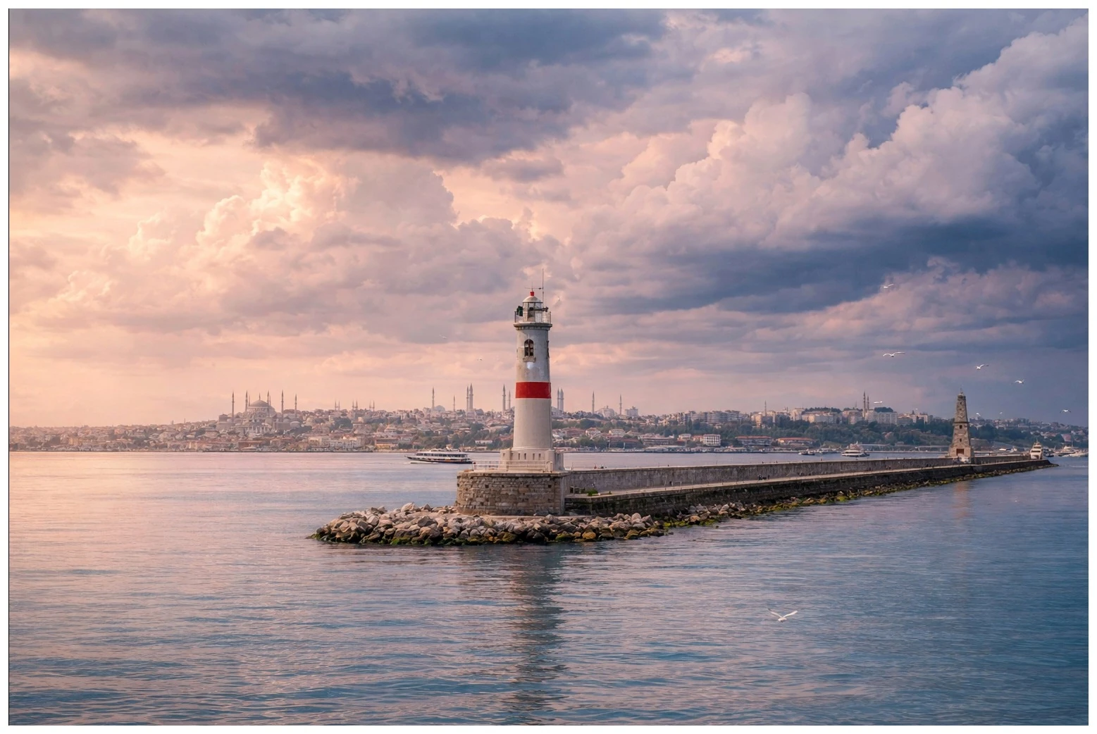 An Istanbul lighthouse on a breakwater beneath an evening sky